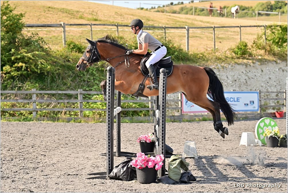 Horse and rider jumping cross-country in Sussex